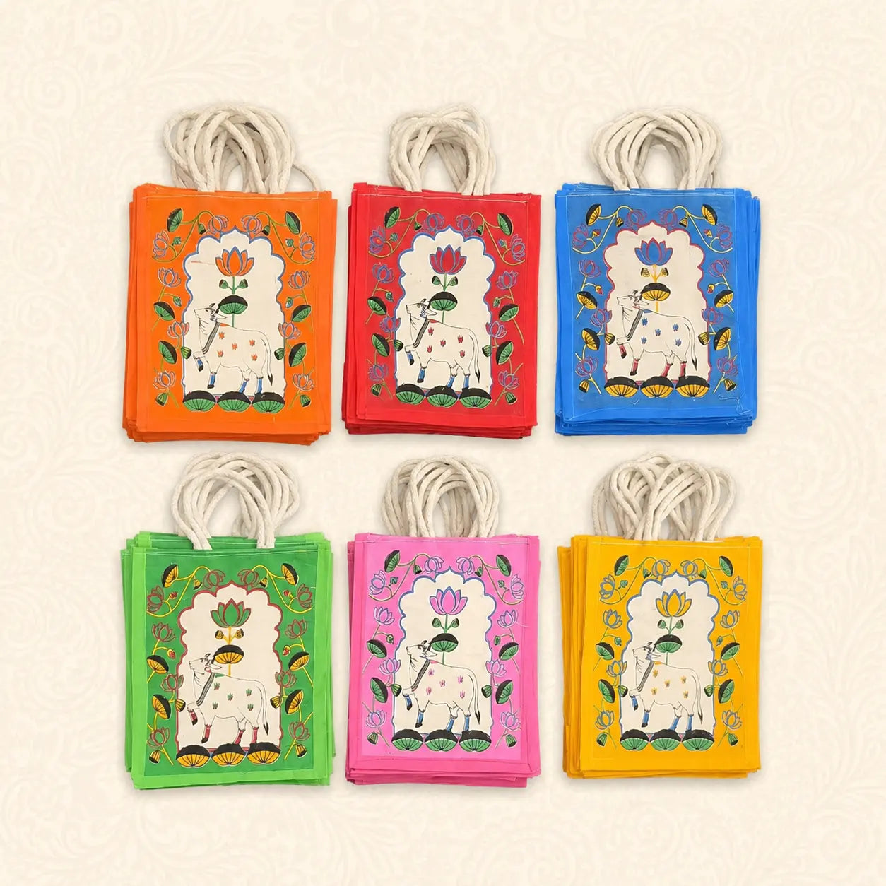Printed jute return gift bags with rope handles in assorted colours for Varalakshmi Pooja and festive gifting