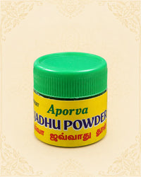 A small jar of Aporva Madhu Powder with a bright green screw-top lid and a yellow label, centered on a light beige patterned background.