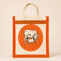 Orange bordered jute return gift bag with cow and calf design and rope handles