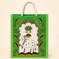Green printed jute return gift bag with cow and lotus design and rope handles